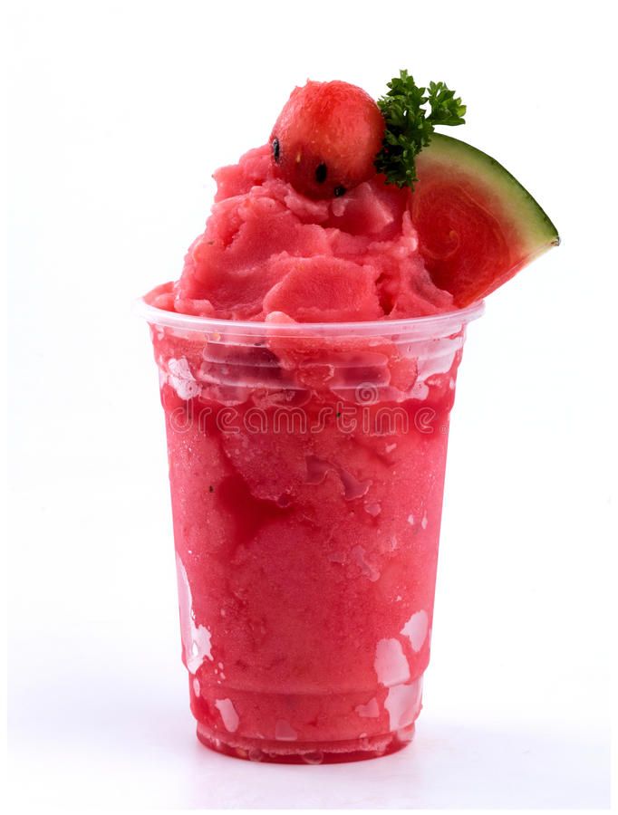 a plastic cup filled with watermelon ice cream and topped with a slice of cucumber