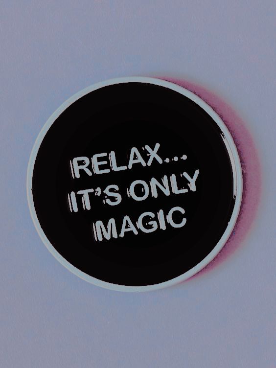 a black and white circle with the words relax it's only magic written on it