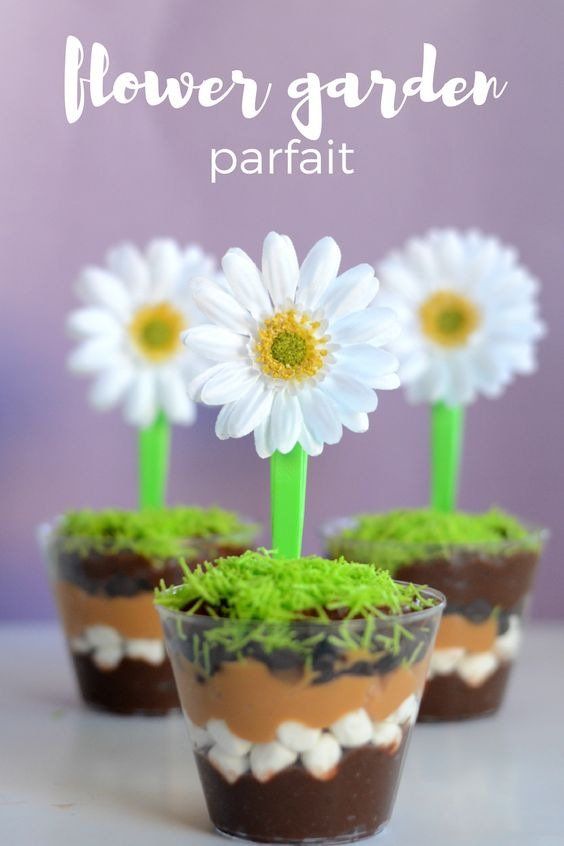 flower garden parfait with grass and daisies in small pots on a table