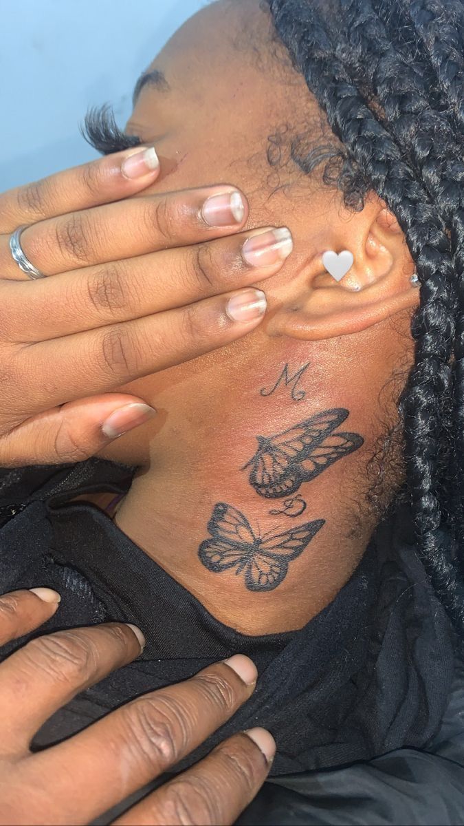 a woman with butterfly tattoos covering her face