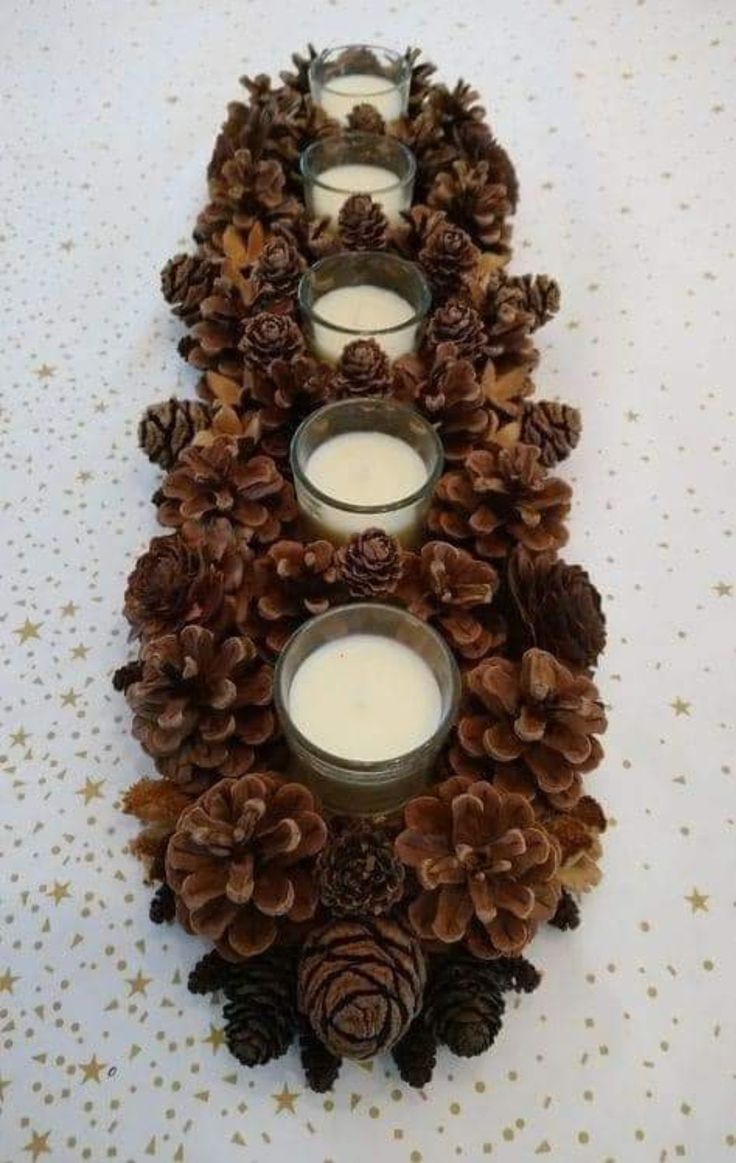 pine cones and candles are arranged on the table