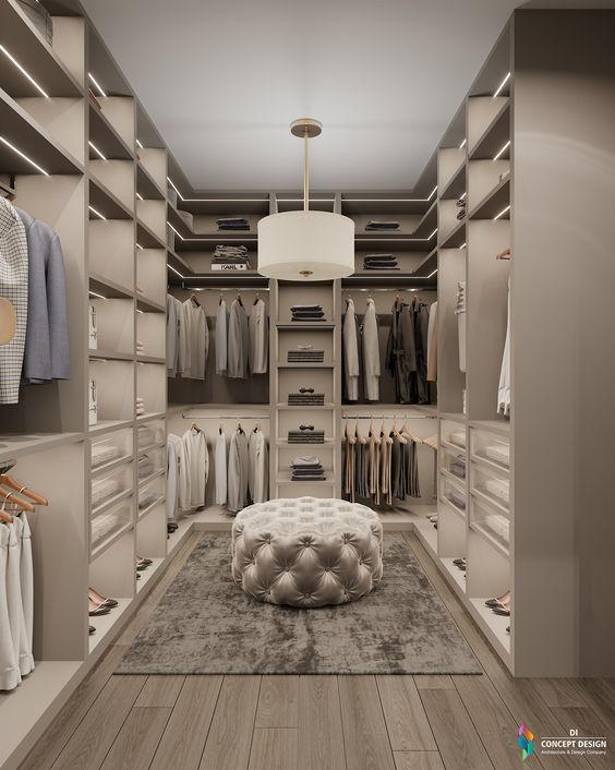 a walk in closet filled with lots of clothes and shoes on shelves next to a lamp