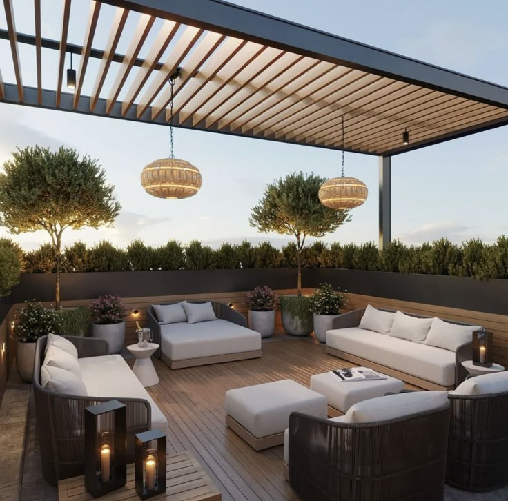 an outdoor living area with couches and lights