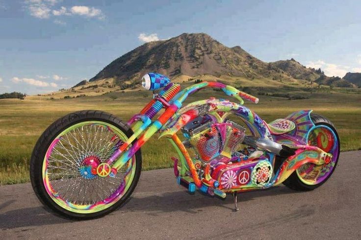 a colorful motorcycle is parked on the side of the road