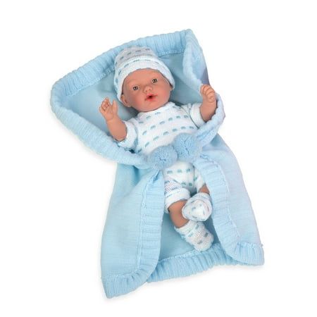 a baby doll laying on top of a blue blanket