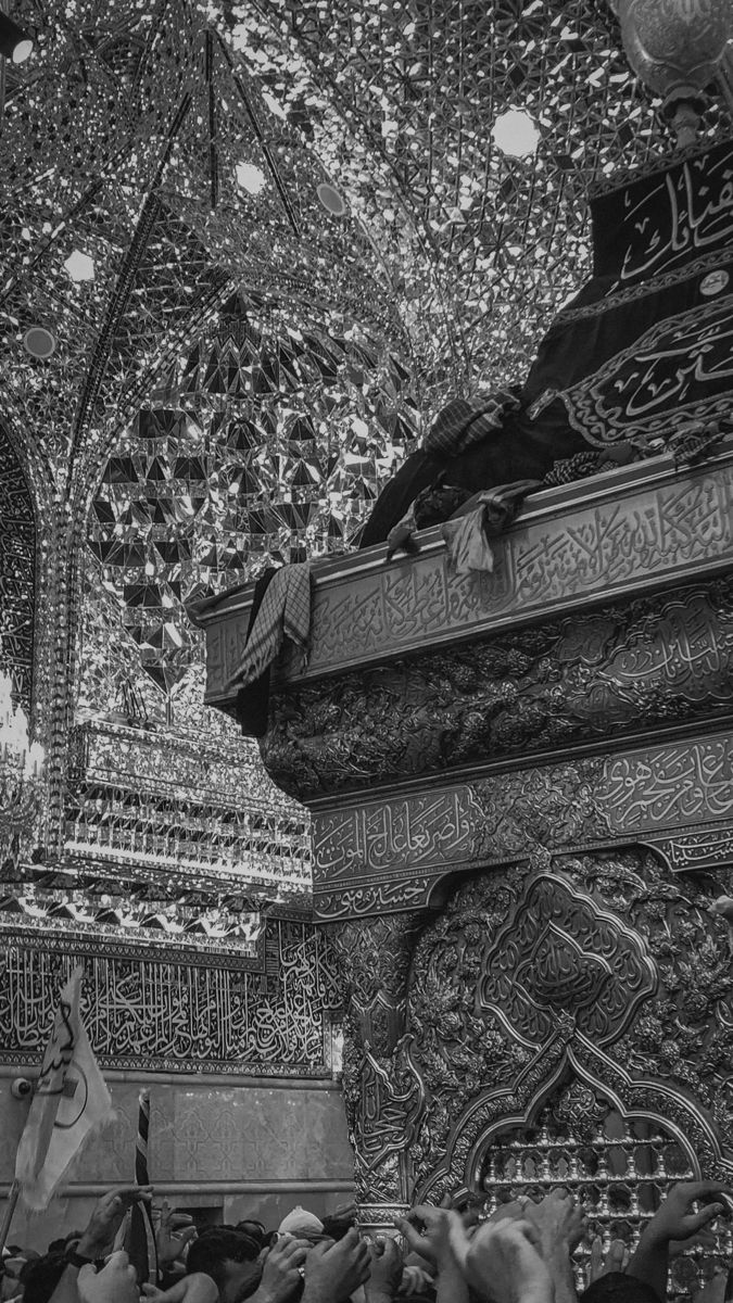 black and white photograph of people in front of an intricately decorated ceiling with lights