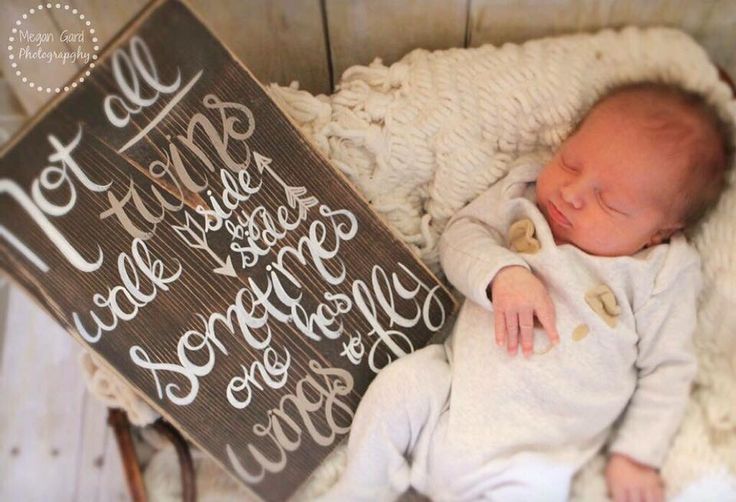 a baby is sleeping next to a sign