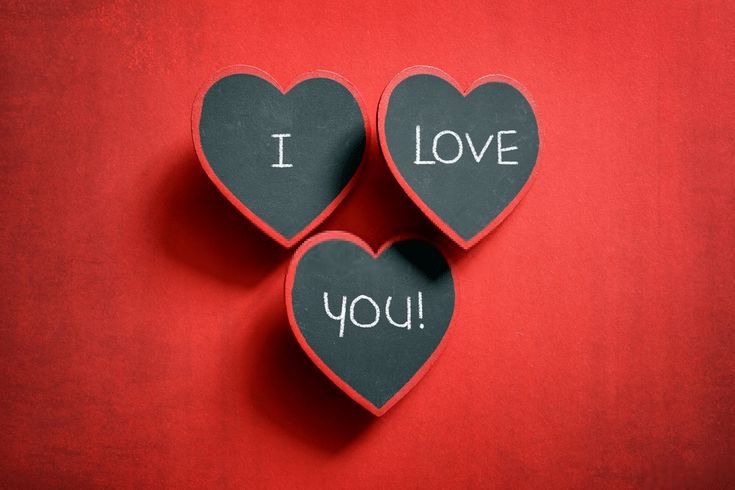 three heart shaped magnets with the words i love you written on them against a red background