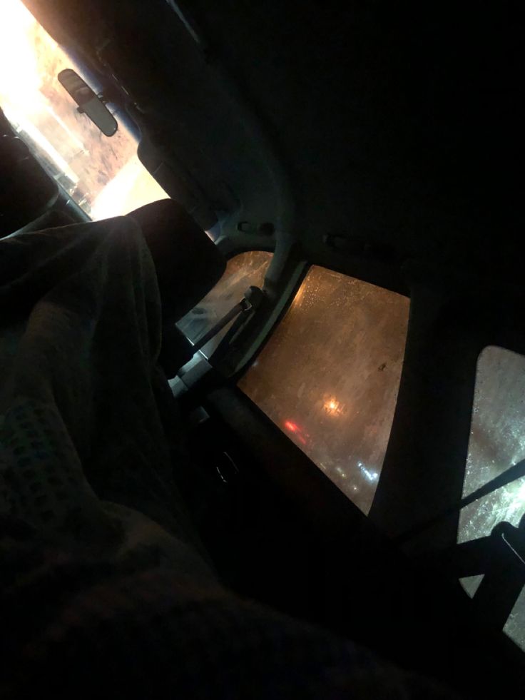 the inside of a vehicle with light coming in from it's rear door window