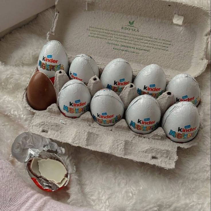 a dozen eggs are in an egg carton on a bed next to a bottle of milk