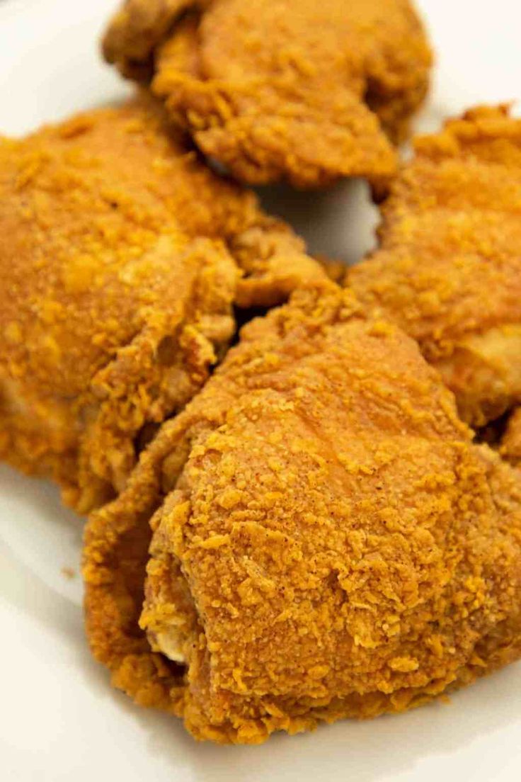 fried chicken pieces on a white plate ready to be eaten