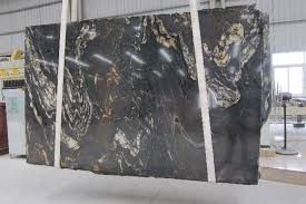 a large black marble slab in a warehouse