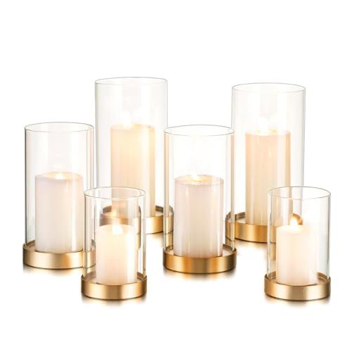 candles are arranged in glass vases with gold rims on the bottom and sides