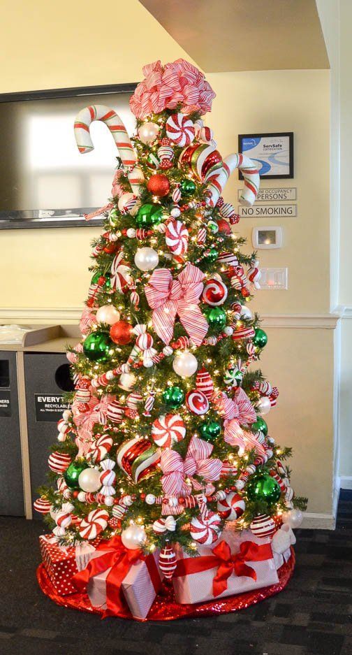 a christmas tree decorated with candy canes and bows