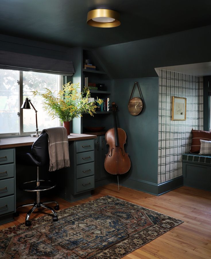 a room with blue walls and wooden floors, an area rug on the floor has a guitar in it