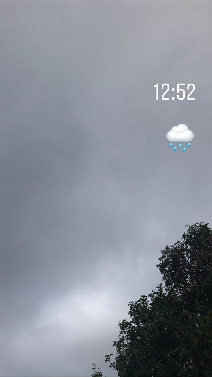 an image of a cloud with rain coming down and the time is 12 52 pm