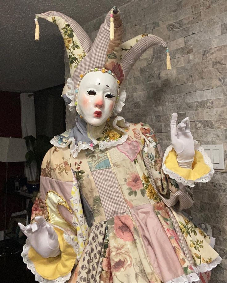 a statue of a woman wearing a mask and dress