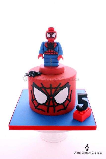 a spiderman cake with the number five on it