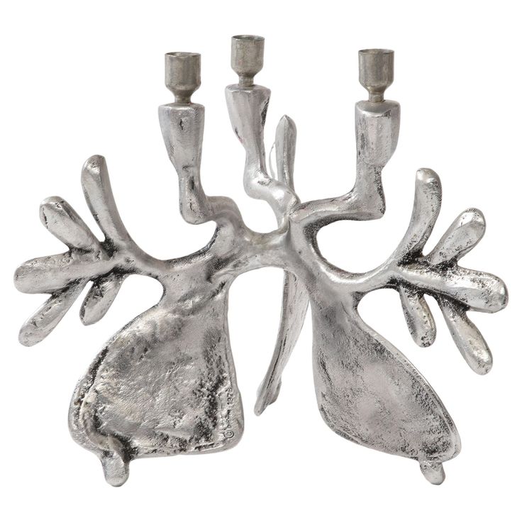 a silver candle holder with three candles in it