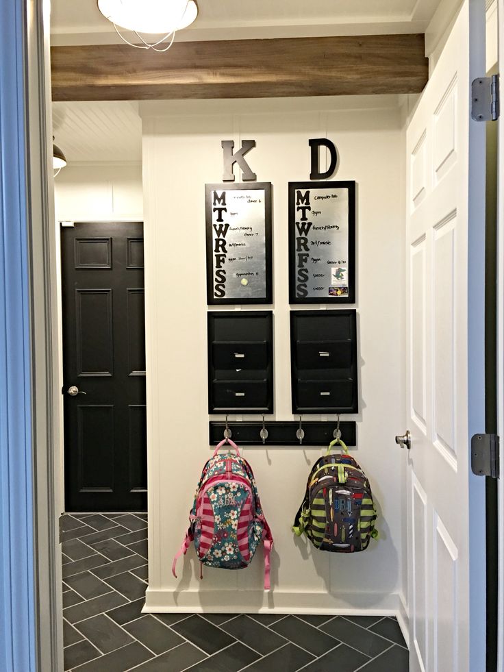 two backpacks are hanging on the wall