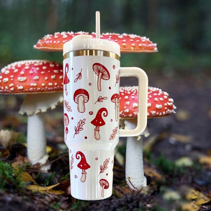 a cup with mushrooms on it is sitting in the grass next to two other cups