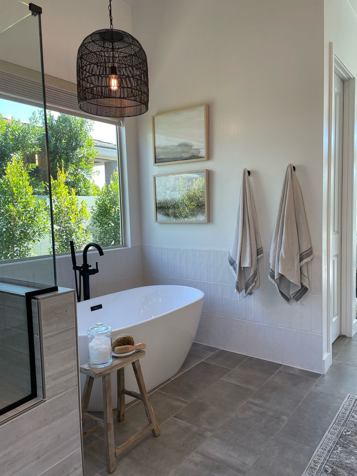 a white bath tub sitting next to a window