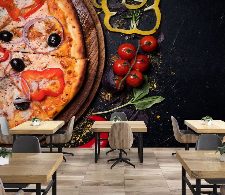 a pizza with tomatoes, onions and olives on the table in a restaurant wall mural