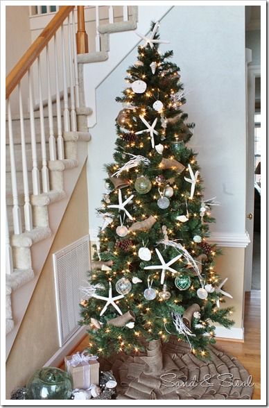 a christmas tree decorated with starfish and seashells