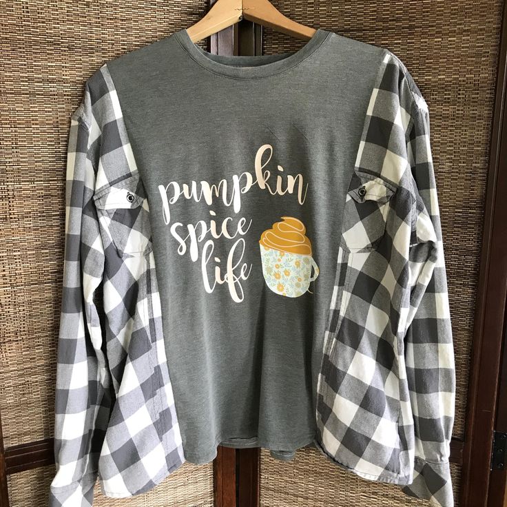 Upcycled oversized flannel tee, size M-L, with pumpkin spice coffee graphic.  This reworked spliced shirt with flannel sleeves would make a cute warm and comfy addition to your wardrobe this fall and winter! (WANT TO SEE MORE FROM THIS COLLECTION? Type RWTA in this store's search field.) These pieces are created to be an oversized fit. Please see measurements and approximate sizing below. DETAILS: APPROXIMATE SIZE:  M-L (depending on desired fit) Brands:  Natural Reflections Materials:  Cotton MEASUREMENTS: Top of shoulder to bottom hem:  26 inches Width across front at armpit:  26 inches This shirt is made from upcycled clothing, meaning previously owned/preloved.  Purchasing upcycled clothing is beneficial to our planet in that it minimizes the amount of discarded materials sent to our l Tshirt With Flannel Sleeves, Upcycled Flannel Shirts Ideas, Upcycle Shirts, Sweatshirt Upcycle, Reworked Flannel, Flannel Shirt Outfit, Flannel Sweatshirt, Cycling Clothes, Spice Coffee