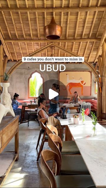 the inside of a restaurant with people sitting at tables