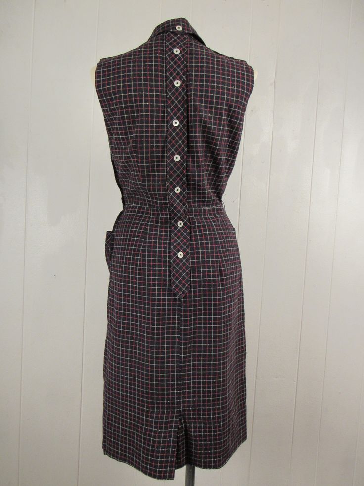 "Vintage 1950s dress. Made of black nubby cotton with red and white windowpane plaid. Has decorative back buttons, two pockets, sleeveless and side zipper. No label. Size small. Actual measurements are: 37\" around the bust 28\" around the waist 38\" around the hips 14\" shoulder to shoulder 41\" overall length In very good condition." Fitted Sleeveless Plaid Vintage Dress, Retro Plaid Fitted Vintage Dress, Fitted Sleeveless Vintage Plaid Dress, Fitted Vintage Cotton Plaid Dress, Retro Cotton Plaid Dress, Windowpane Plaid, Checkered Dress, Vintage 1950s Dresses, 1950s Dress