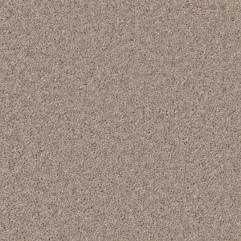 a close up view of the surface of a beige carpet with small speckles