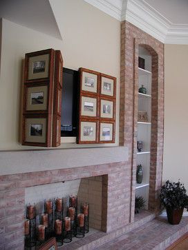 a living room with a fire place and pictures on the fireplace mantel above it