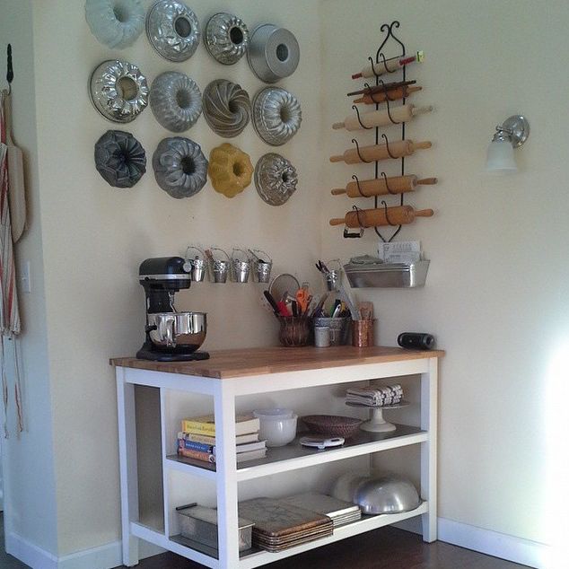 a kitchen area with various items on the wall and plates hanging on the wall behind it