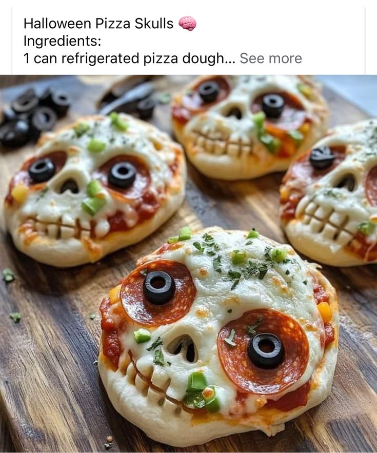 four pizzas with eyes on them sitting on top of a wooden cutting board