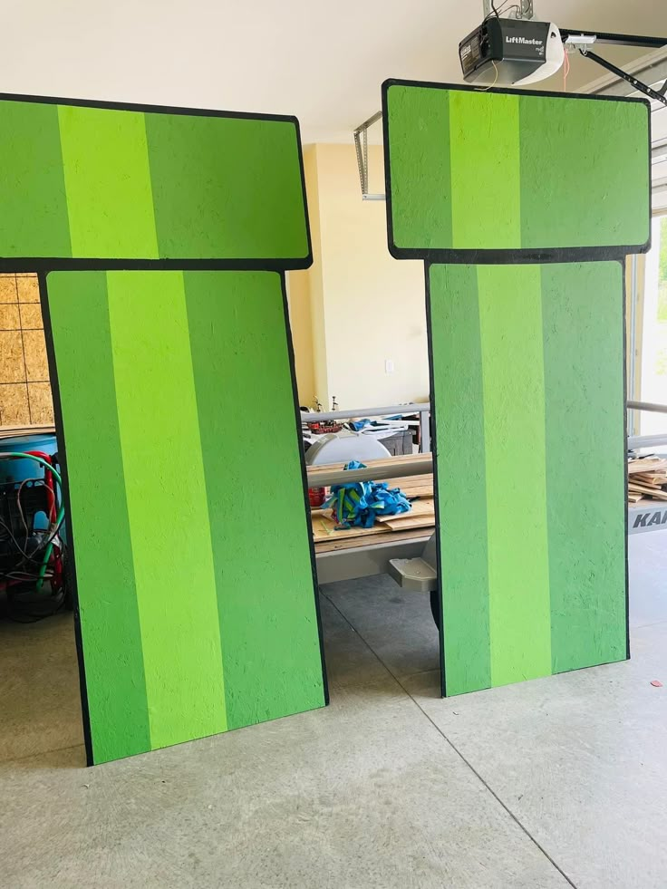 two large green and black doors in a room