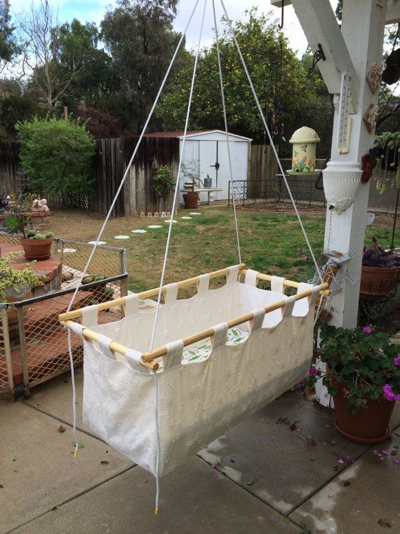 a hammock hanging from the side of a wooden structure in a back yard