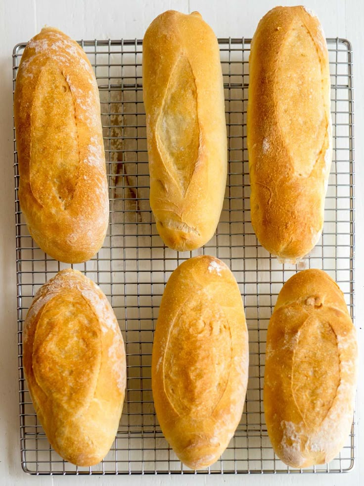 six loaves of bread on a cooling rack