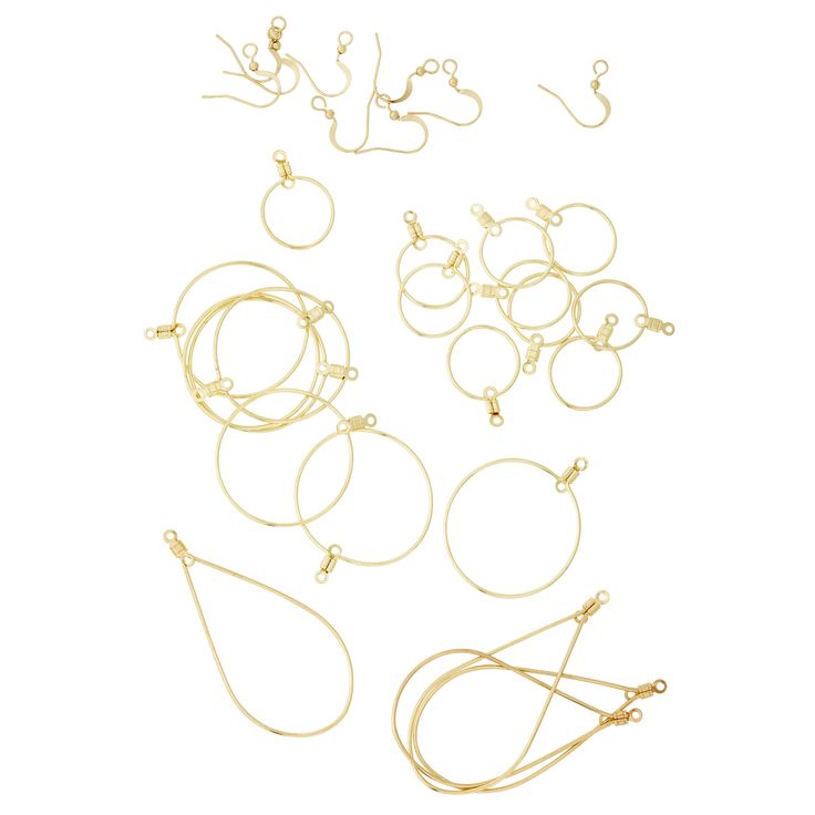 several pairs of gold colored metal rings and earring wires on a white background with clippings