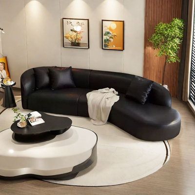 a modern living room with black and white furniture