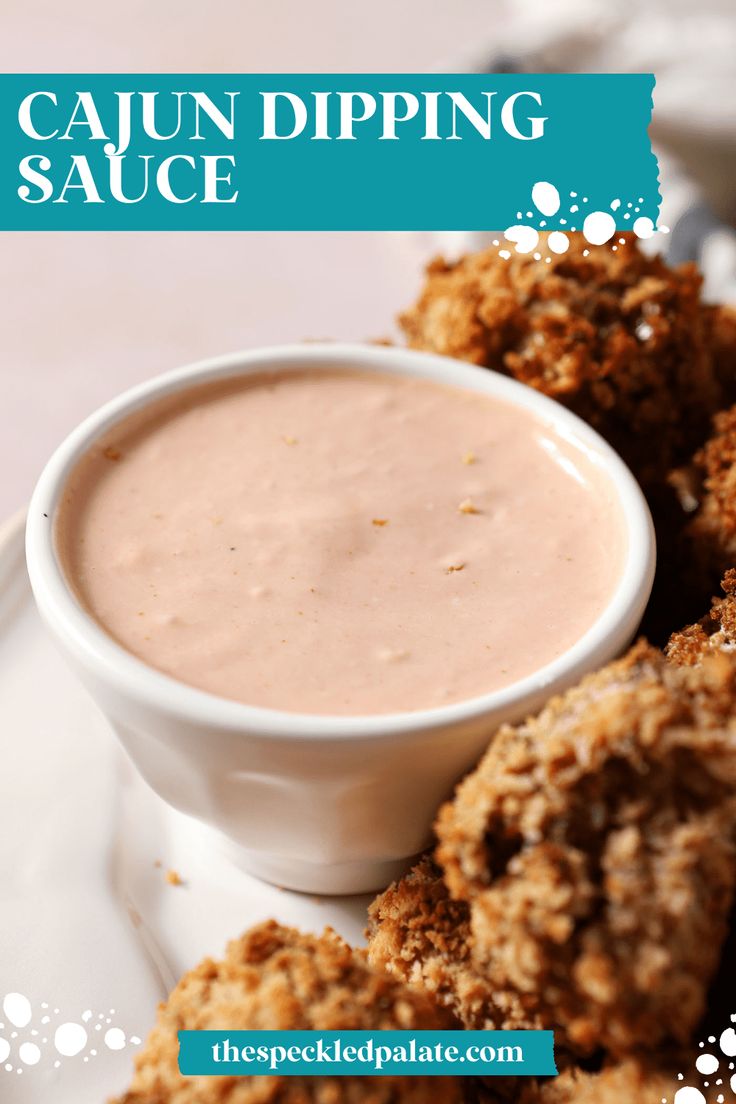 a white plate topped with fried food and dipping sauce