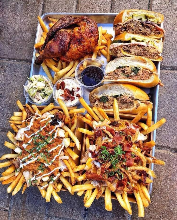 a tray filled with lots of different types of food on top of a brick floor