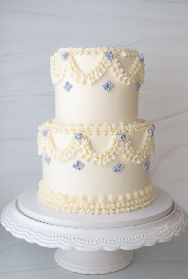 a three tiered cake with blue and white decorations