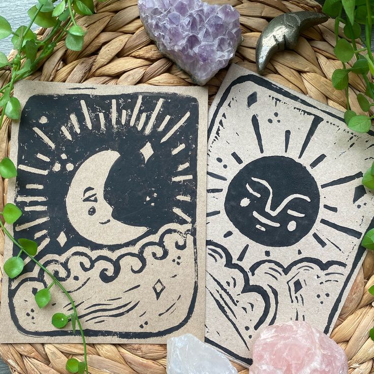 two coasters sitting on top of a basket next to some rocks and greenery