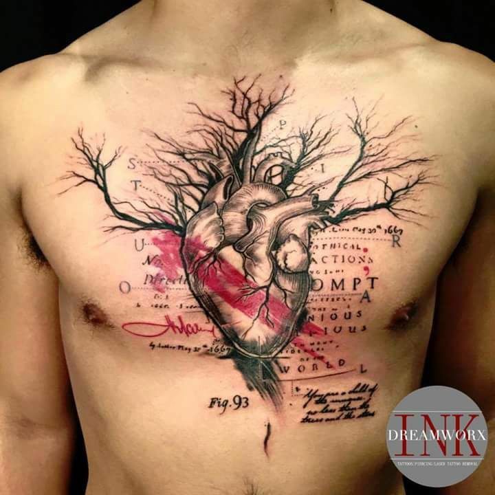 a man's chest with a tree and heart on it