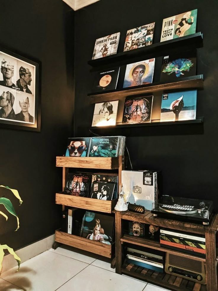 a record player is sitting on top of a shelf in a room with black walls