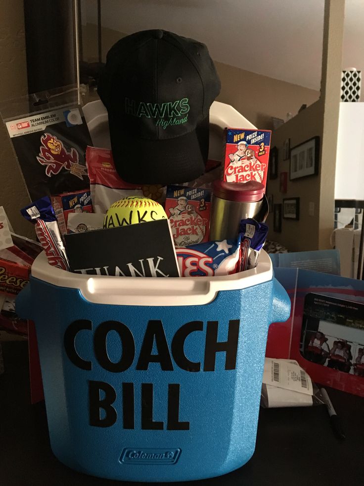 a blue cooler filled with items sitting on top of a table