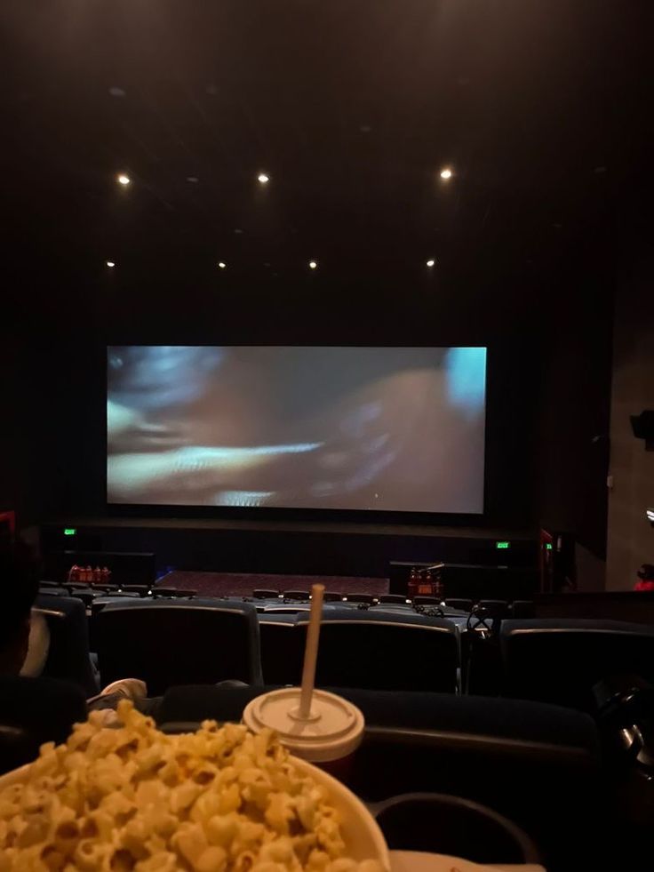 a large bowl of food sitting on top of a table in front of a screen