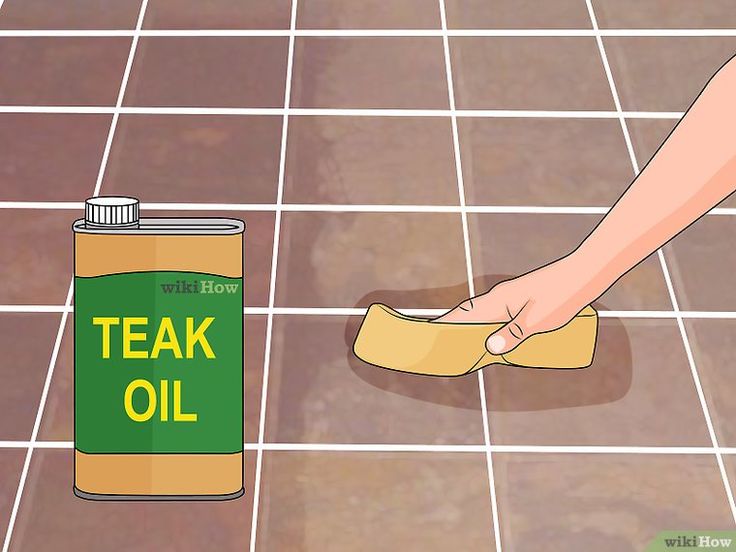 a can of teak oil being used to clean the floor with a cloth on it