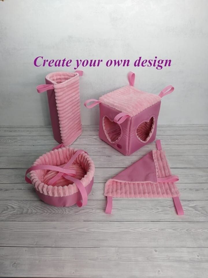 some pink items are sitting on the floor and there is a sign that says create your own design